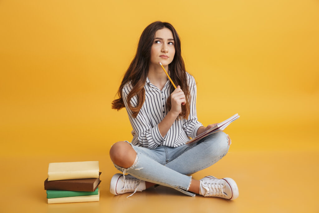 portrait pensive young girl making notes